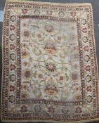 An Indian carpet of Ziegler style, the ivory field with bold flowerheads, palmettes and vine and