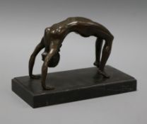 A bronze figure of an acrobat length 25cm