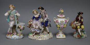 Three Continental figure groups and a lidded floral encrusted vase tallest 18.5cm