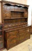 An 18th century style oak dresser and rack W.167cm