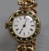 An early 20th century 9ct gold gem set manual wind wrist watch on a 9ct gold expanding bracelet.