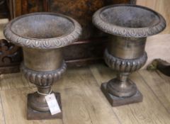 A pair of cast iron urns W.26cm