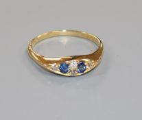 An Edwardian 18ct gold, sapphire and diamond six stone ring, size V.