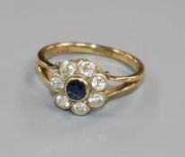 An 18ct gold, sapphire and diamond flower head cluster ring, size N.