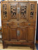 A Chinese carved and pierced wood cabinet W.120cm