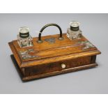 An oak desk stand with silver-plated mounts, fitted two plain inkwells, pen tray and drawer with