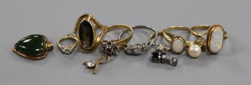 A palladium and three stone diamond ring, four 9ct gold and gem set rings, four gem set pendants and