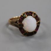 An early 20th century yellow metal, white opal and gem set ring in the "suffragette" colours, size