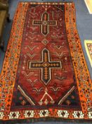 A red ground Shiraz rug 265 x 139cm