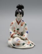 A Japanese Arita figure of a bijin, painted in kakiemon palette height 15.5cm