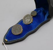 Three Roman coins, yellow metal mounted as a tie pin and button set, in French fitted box.