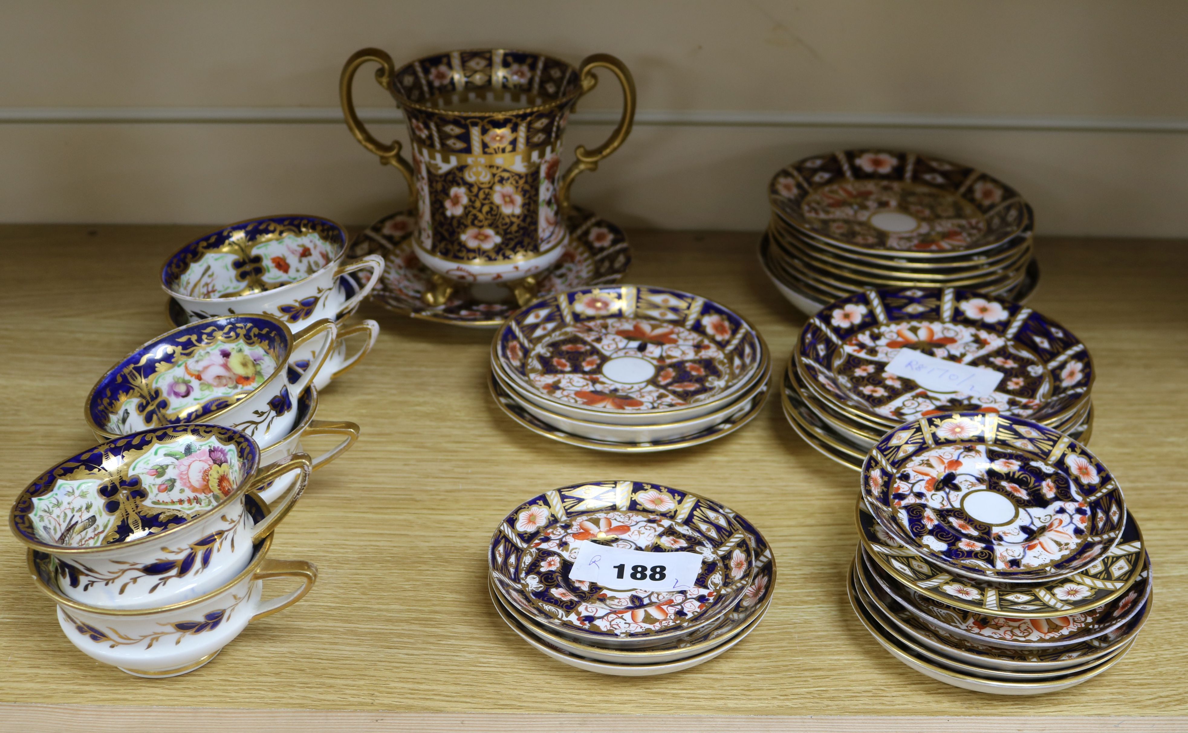 A large quantity of Royal Crown Derby Imari style patterned plates, saucers and a two-handled base