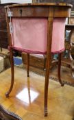 A George III satinwood oval work table, having hinged top and pink silk work well, raised on slender