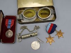 A pair of mid 20th century motorcycle goggles, a Scottish police whistle, three WWII medals and a