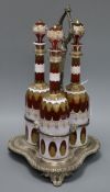 Three Bohemian overlaid glass decanters in decanter stand height 45cm