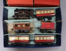 Hornby - 0-gauge clockwork tank loco, 3 carriages, 2 wagons in an associated box.