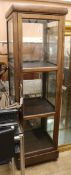 A four sided glazed square section display cabinet W.50cm