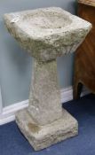 A pair of stone planters on columns W.40cm approx
