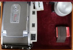 An early Polaroid camera in leather case and a tennis racket and press