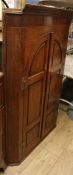 A George III oak and mahogany corner hanging cabinet W.90cm