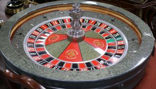 A roulette wheel by "John Huxley" Grosvenor casino diameter 80cm approx.