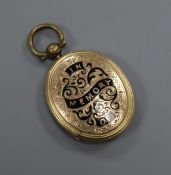 A late Victorian engraved yellow metal and black enamel oval mourning locket, 27mm.