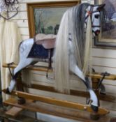 A Stevenson Brothers, 1994, dapple painted carved wood rocking horse on supports W.142cm