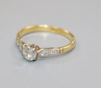 An 18ct gold and single stone diamond ring with diamond set shoulders, N/O.