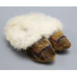 A pair of childs North American Indian seal skin and fur lined shoes/boots