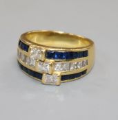 A modern 18ct gold and triple row sapphire and diamond channel set dress ring, size P/Q.