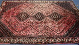 A red ground rug 294 x 215cm