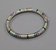 An Egyptianesque white metal and enamel hinged bangle.