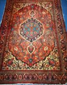 A Persian red ground rug 194 x 137cm