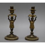 A pair of Italian bronze putto candlesticks, height 21.5cm