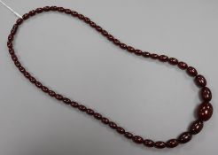 A single strand graduated simulated amber necklace, gross 53 grams, 74cm.