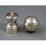 A silver pepper mill and a spherical silver salt