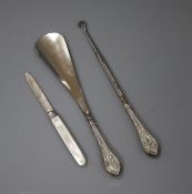 An early 20th century silver handled shoe horn and button hook and a silver mother of pearl fruit