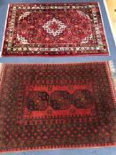 Two small red ground rugs 141 x 102cm. and 146 x 103cm