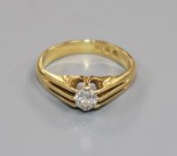 A 1930's 18ct gold and claw set solitaire diamond ring, size K.