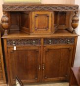 A 1920's oak court cupboard W.137cm