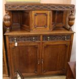 A 1920's oak court cupboard W.137cm