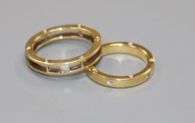 Two modern 18ct gold and diamond set bands, one with openwork shank.