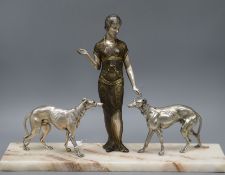 An Art Deco spelter silvered metal model of a girl with two dogs, on marble base height 37cm