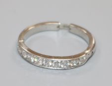 A white metal and nine stone diamond half eternity ring, with extendable shank, size L-Q