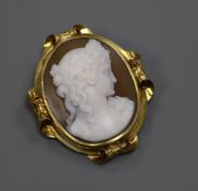 A yellow metal mounted oval cameo brooch, carved with the bust of a lady to sinister, 43mm.