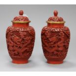 A pair of Chinese cinnabar lacquer dragon jars and lids height 18cm