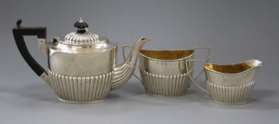 An Edwardian demi fluted silver batchelor's three piece oval tea set, William Devenport, Birmingham,