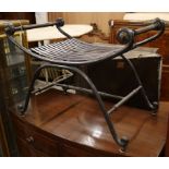 A wrought iron X shaped stool W.78cm