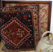 A framed tapestry and a carpet cushion