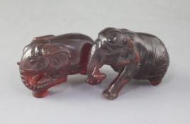 Two natural cherry amber figures of elephants, late 19th/early 20th century, each naturalistically